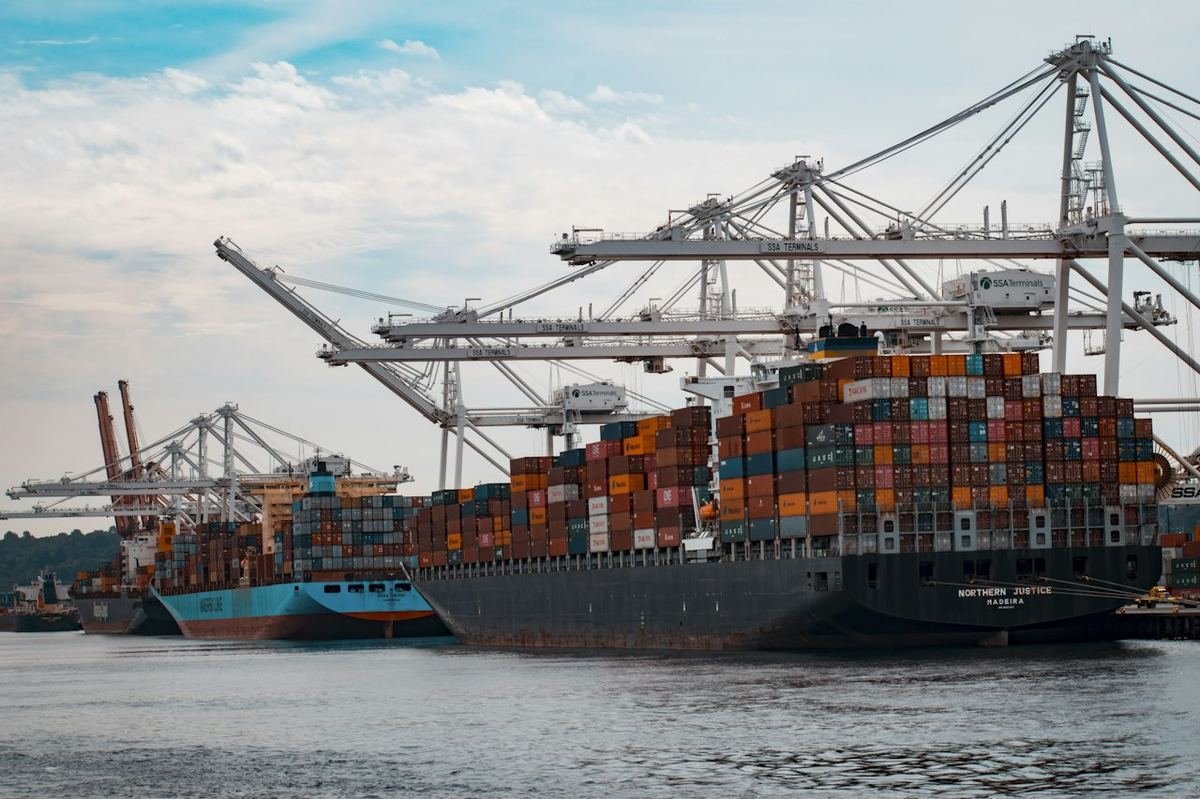 Container ship being loaded under gantry cranes at a port